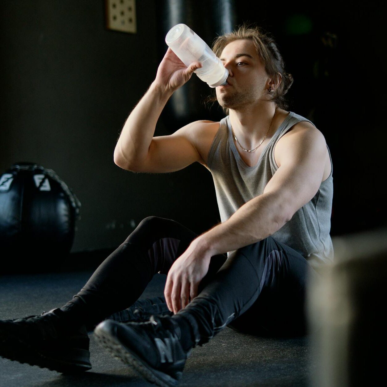 man sitting on the floor and drinking water